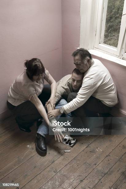 Two Parents Hold Young Mans Arm From Reaching Syringe Stock Photo - Download Image Now