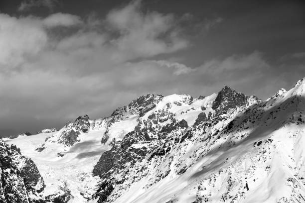 istock View on snowy mountains with glacier and cloudy blue sky 1082195476