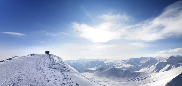 istock Panoramic view on top station of ropeway and snowy mountains 1082195484