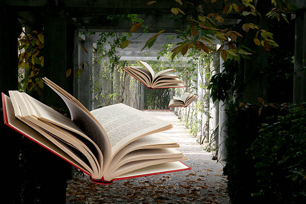 Books flying through abandoned hallway stock photo