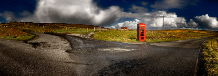 View of countryside landscape, with a red phone box, in the Isle of Skye, Inner Hebrides, Scotland, UK