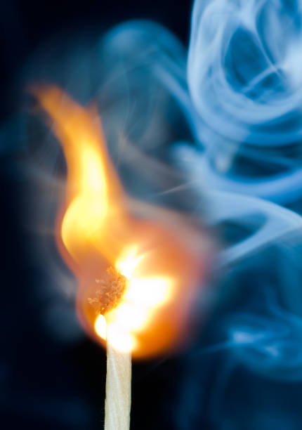 istock Ignition of match with smoke, isolated on black background 1082197082