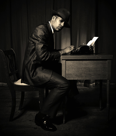 a reporter/private detective from the 50s using a a typewriting machine