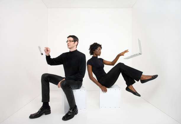 Man and woman using floating electronic devices  levitation stock pictures, royalty-free photos & images