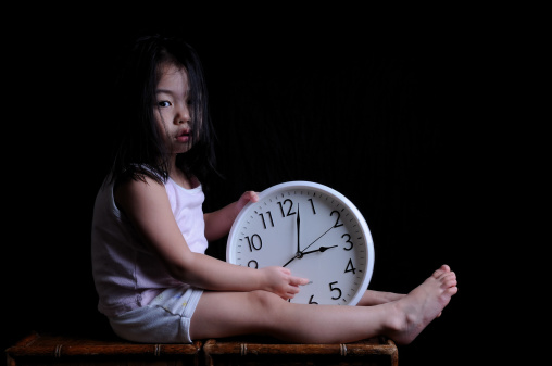 little girl holding a clock in wait.  Asian kids\nhttp://www.istockphoto.com/file_search.php?action=file&lightboxID=4920170