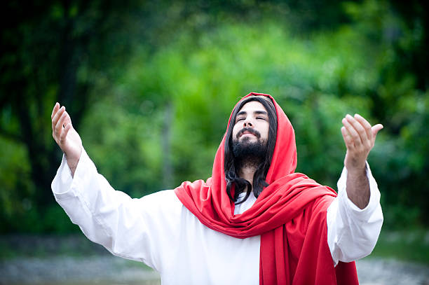 istock Man Who Looks like Jesus Christ Praying Outside 108219931