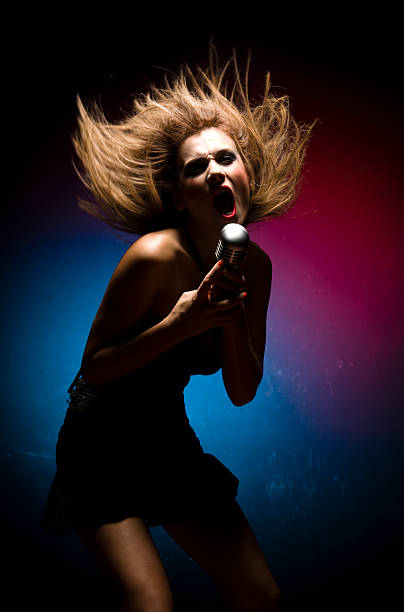 istock Young Woman Singing Loudly into Microphone 108220035