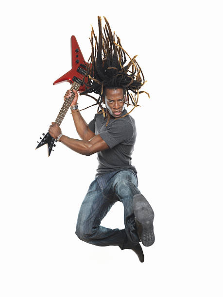 istock Man playing electric guitar and jumping 108220135