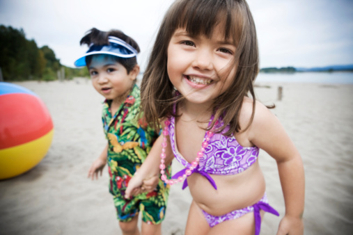 Two little kids excited to be at the beach.