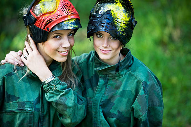 Blurred, military and people with guns for paintball, training and action game in nature. Fitness, defocused and soldier men shooting for war on battlefield, physical activity or cardio in a forest