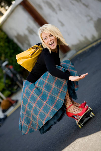 Young Woman Wearing High Heels and Riding Skateboard  extreme skateboarding stock pictures, royalty-free photos & images