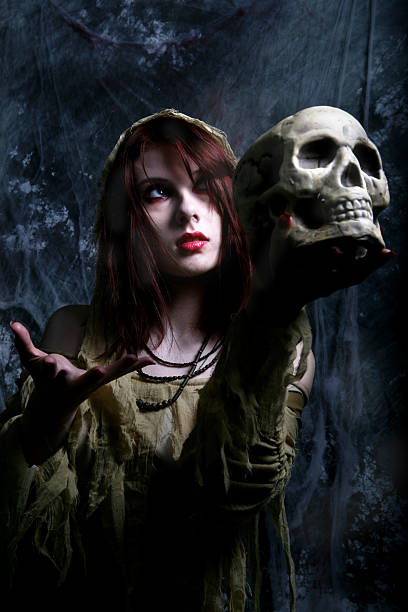 istock Spooky Young Woman Holding Skull 108220525