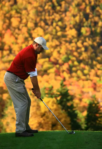 Photo of Senior Golfing During Autumn