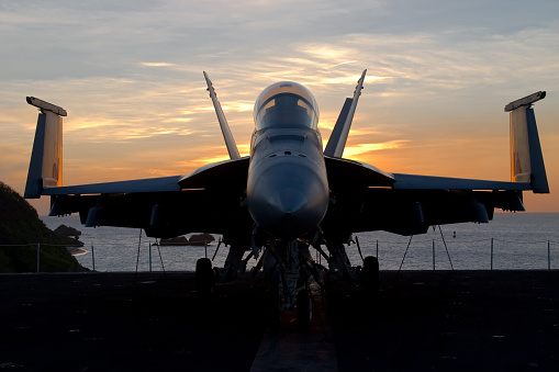 A modern jet fighter at sunset.