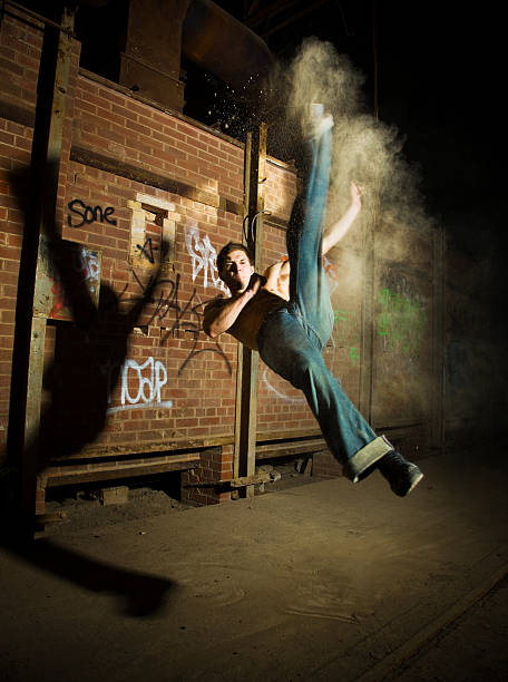 istock Young Male Fighter Doing Flying Kicks at Night 108220882