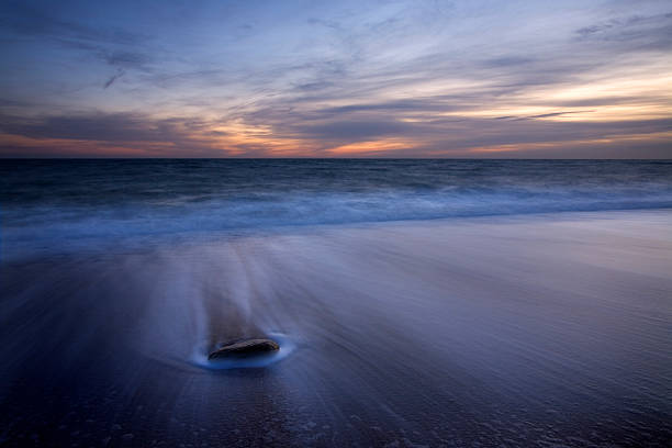 istock Sunset Over Ocean at Coastline on Beach 108220971