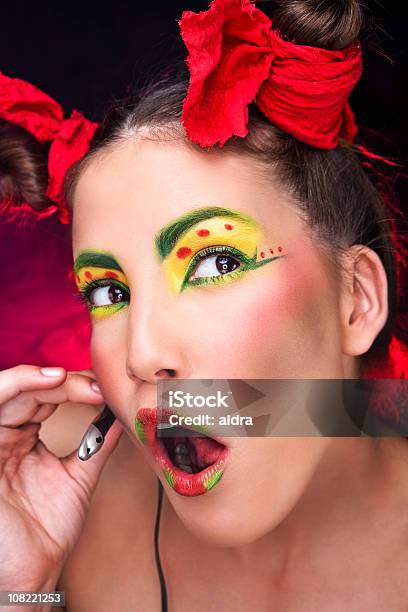 Young Woman Posing With Strange Makeup And Headset Stock Photo - Download Image Now