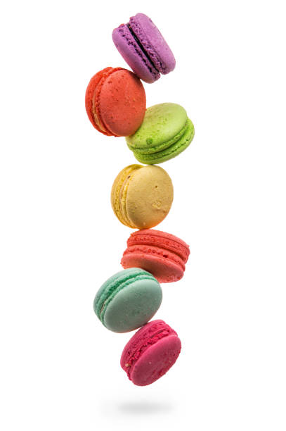 istock Close up. Colorful and falling french macarons isolated on white background. Copy space. 1082212996