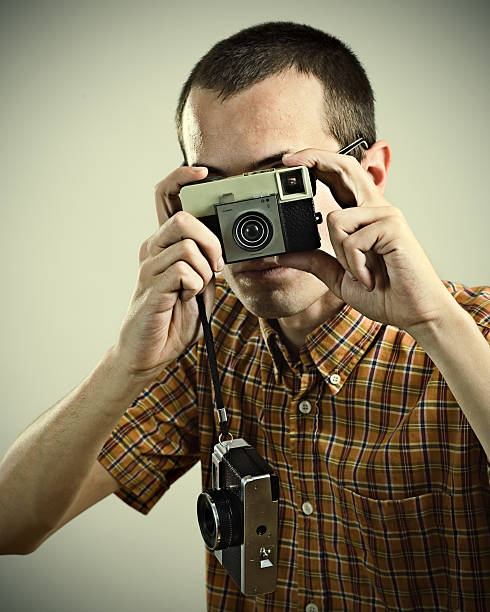 istock Young Man Taking Pictures with Vintage Camera 108221367