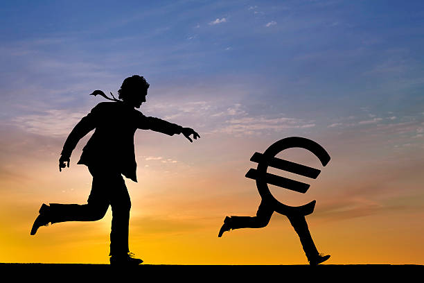 ビジネスマン追跡ユーロ通貨のサイン - european union currency euro symbol currency chasing ストックフォトと画像