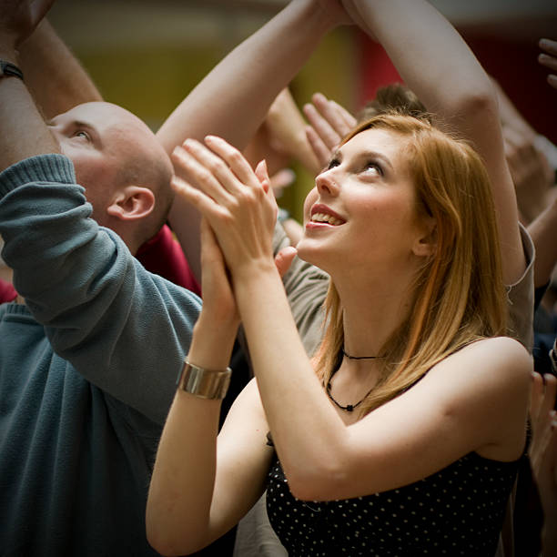 istock Young Woman Standing in Crowd and Clapping 108221482