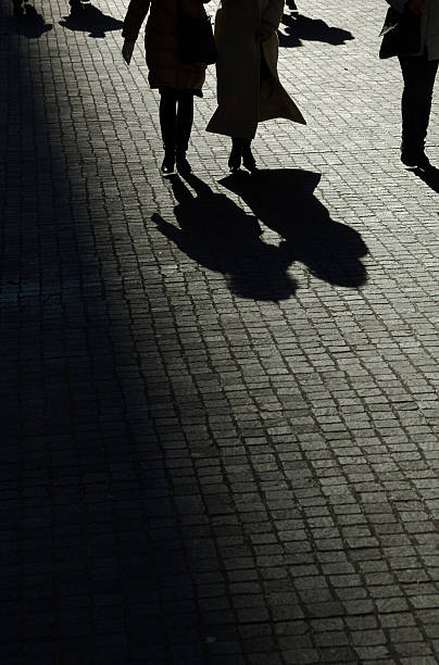 istock Silhouette of People Walking Down Cobblestone Road 108221525