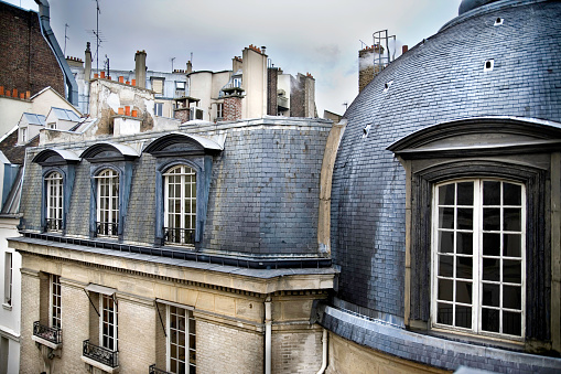 View of city rooftops in the rain in Paris, France.