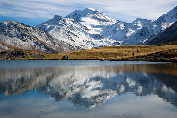 istock People Walking in Mountain Valley and Field along Lake 108221655