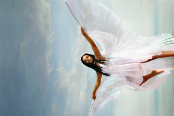 Woman Wearing White Dress with Wings stock photo