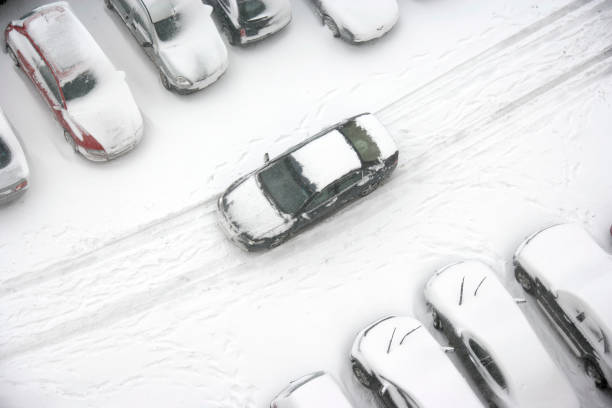 istock Car Driving Through Snowy Parking Lot 108222404
