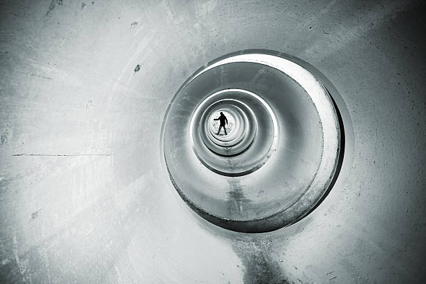 Figure in a cement tunnel. stock photo