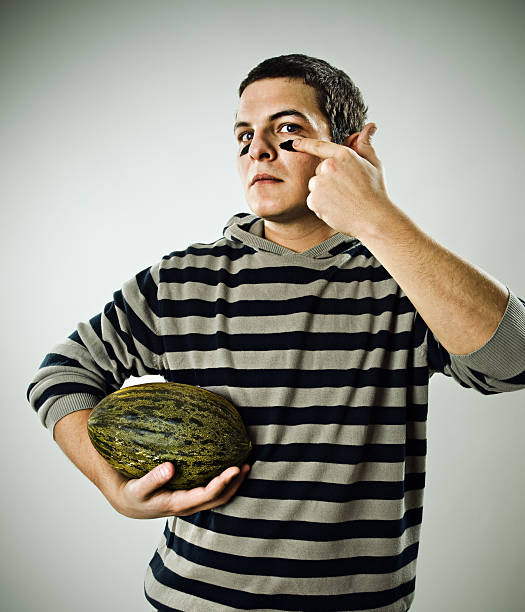 Man Drawing Football Lines on Face