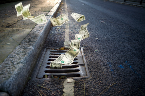Money falling in a manhole