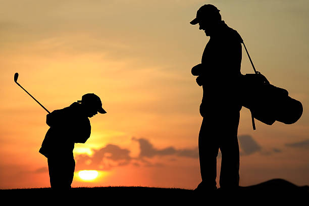 istock Father and Son Golfing at Sunset 108222679