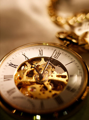 Close up of a gold pocket watch.