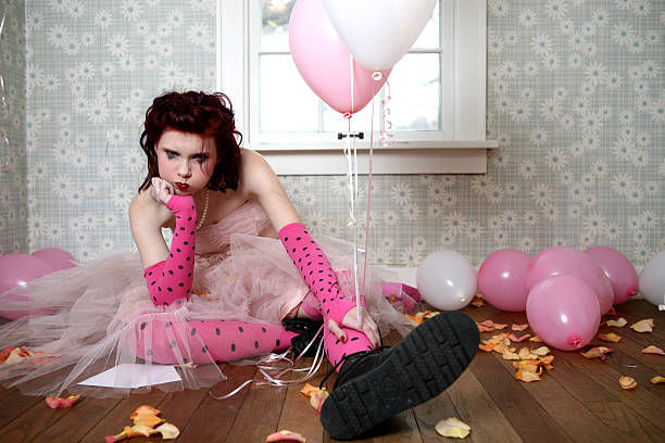 istock Depressed Young Sitting on Floor Among Chips and Balloons 108222781