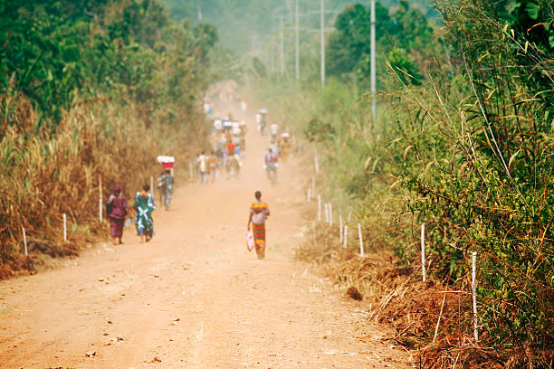 People Walking Down Road in Africa stock photo