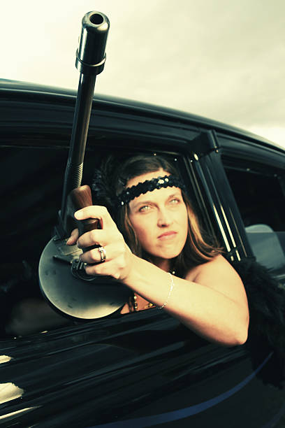 Woman Holding Tommy Gun Outside of Car stock photo