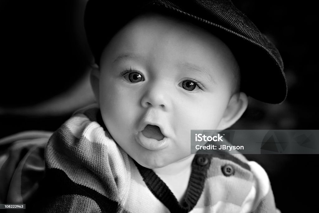 Baby Girl Drooling, Black and White Closeup black and white portrait of a precious six month old baby girl wearing a hat and a striped dress with slobber. 2-5 Months Stock Photo