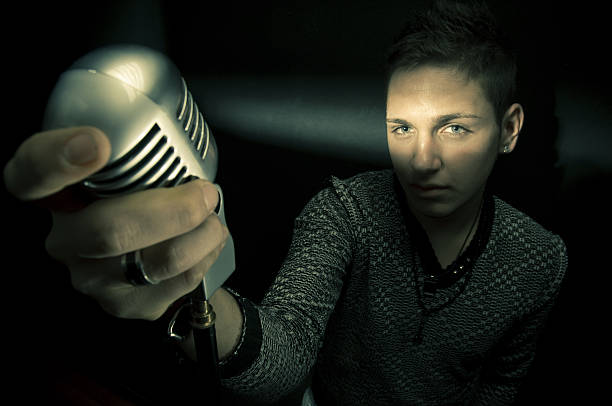 istock Young Man Singing and Holding Old Style Microphone 108222991