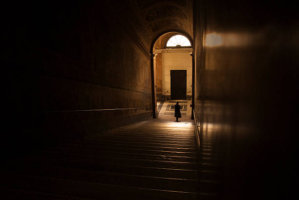 istock woman walking down a staircase into to light 108223104