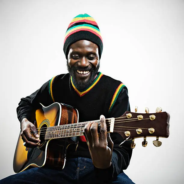 Photo of Rastafarian Man Playing guitar