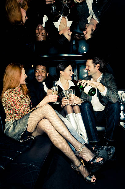 istock Yong couples in back of limousine 108223170