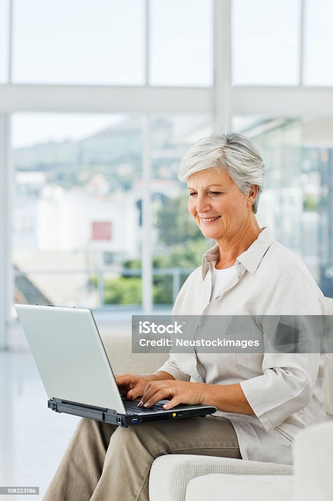 Sênior Mulher de negócios usando o laptop em casa - Foto de stock de Terceira idade royalty-free