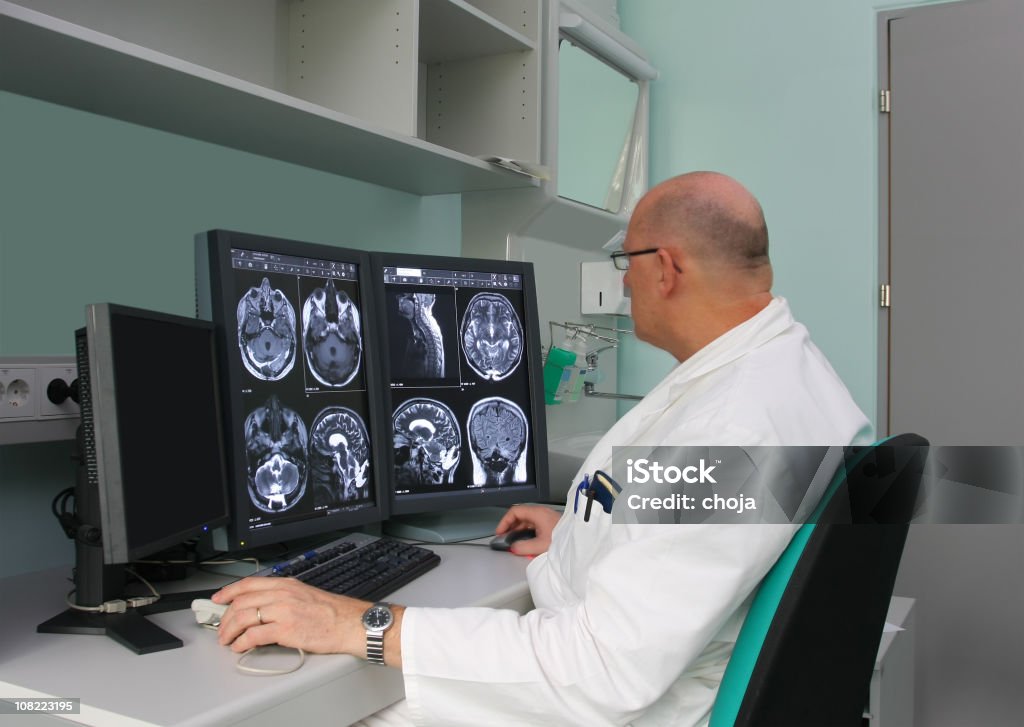 Radiologist is examing MRI scans  Radiologist Stock Photo
