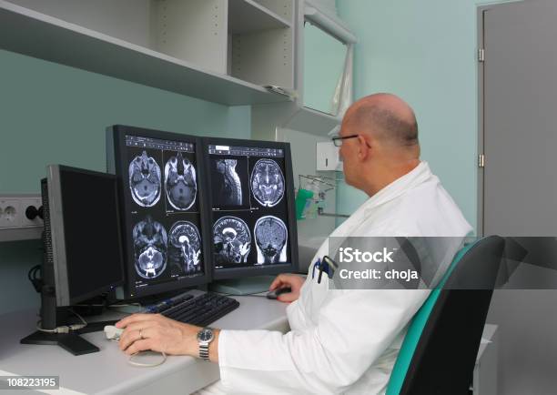 Radiologist Is Examing Mri Scans Stock Photo - Download Image Now - Radiologist, Computer Monitor, Medical X-ray