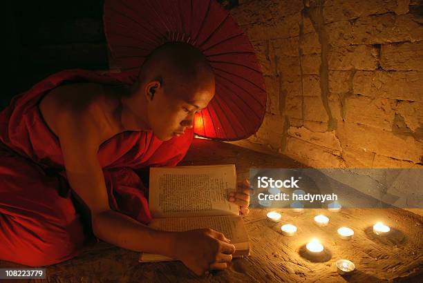 Young Monk Reading A Book Stock Photo - Download Image Now - Candle, Stone Wall, Adult