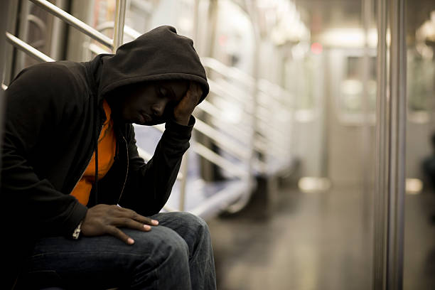 Black Man with Head in Hands on Subway, Copy Space