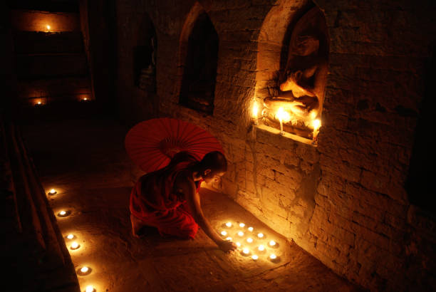istock Buddhist monk praying in temple 108223824