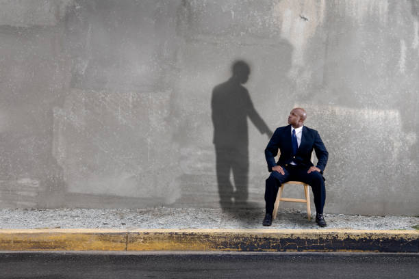 Shadow watching over man stock photo